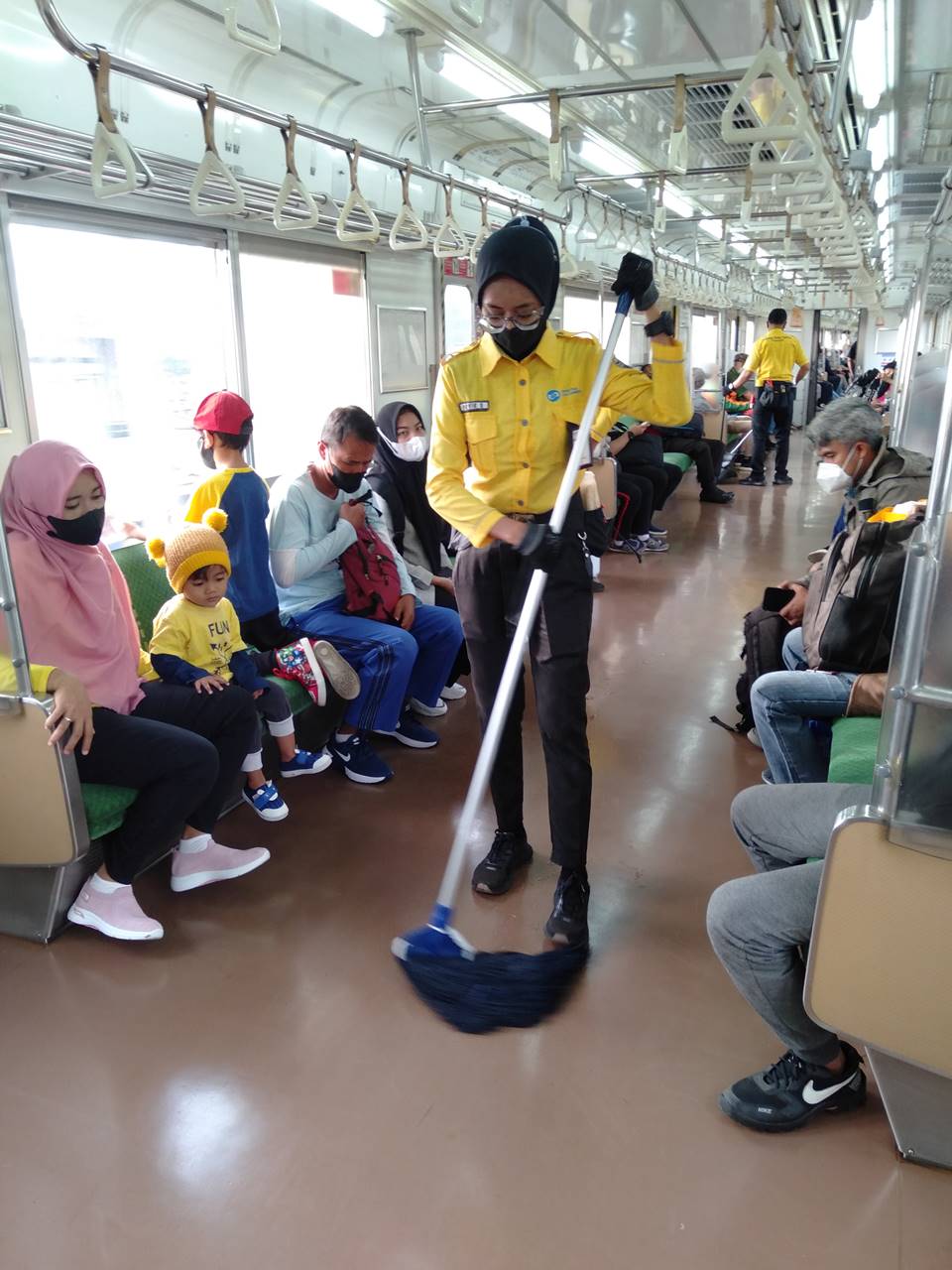 Cleaning Service Officers on Duty : Indonesia Commuter Train